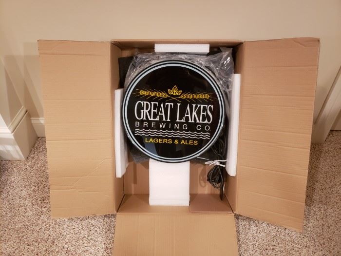 New in box double-sided Great Lakes Brewing Company lighted beer sign. Item was tested and  powers on. This would be a great addition to your man cave. Measures approximately 16 in in circumference.