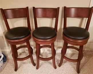 Like new set of 3 wooden swivel bar stools. Black leather seating, all in great condition, very comfortable. Total height is approximately 44 inches, seat height is approximately 29 inches.