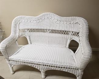 Like new white wicker settee, great item for your patio. Item is constructed of white plastic. Very sturdy and clean. Measures approximately 54 inches across by 29 in deep.