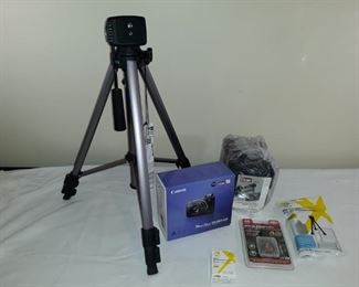 New in box Canon camera with accessories and new tripod.