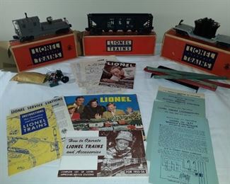 Three vintage train cars and misc pieces. Instruction manuals and some empty Lionel boxes.