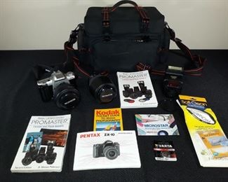 Pentax Zx-10 Promaster with lens and flash. Includes various accessories.