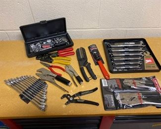 Grouping of a variety of handheld tools including pliers, wrenches, & lugnuts