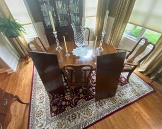 The table is 5ft long, 3.5ft Wide, 2.5ft tall. It comes with 4 matching chairs along with 2 1.5ft leaves making the table as long as 8ft. It does not include the contents on the table.