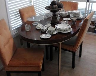 Modern dining table with 3 leaves and four chairs.