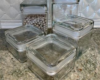 Item 238:  (5) Glass canisters with one containing pie weights: $38