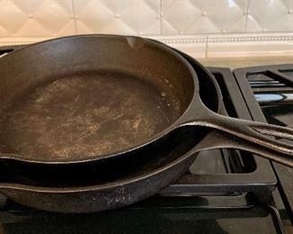 Item 247:  (2) Cast iron pans - larger is Lodge and the smaller one is just Made in USA: $25