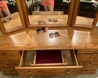 Hidden jewelry drawer in the Michael Howard bedroom set. The mirrors swivel.
