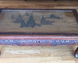 Carved Asian coffee table with small drawer on both sides at center (42”L, 21”D, 16”H)
