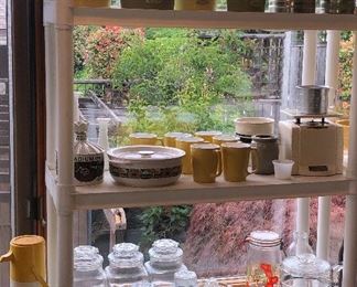 Yellow & green Tupperware canister set, vintage sifters, Kingdome bottle, yellow Centura by Corning mugs, vintage Universal kitchen scale, glass canisters, reamers, Pyrex coffee pot (no guts)