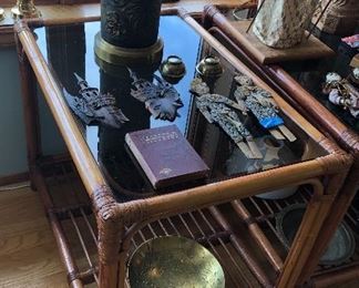 One of a pair of bamboo end tables with smoked glass top (30” x 20” x 24”H) + pair of Bali coin figures, Chinese brass bowl