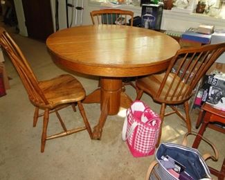 Oak Table with 5 leaves and 4 chairs lion claw feet 40" round can go to 9' with the leaves $300