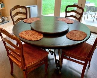 $1,595 Wrought iron and wood hand crafted table by Creative Metal and Wood. Table 29.5"H x '5' Diameter; 16 inch integrated leaf expands to make oval table. Detachable matching Lazy Susan 30"D included.