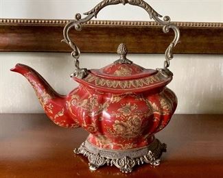 $90  Porcelain red teapot on metal stand with metal finial and handle.  10"H