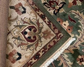 Detail: Area rug in greens, taupe and cranberry