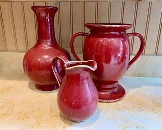 Detail:  Three Pottery Barn red ceramic glazed vases and urns.