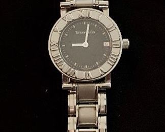 $625. Tiffany ladies "Atlas" stainless steel watch with date complicate.  Stainless steel link band and  butterfly clasp.   Minor scratches and wear evident. Personalized on reverse.