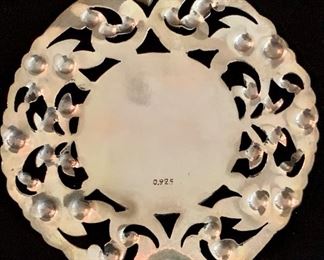 Detail: Round filigree pendant with angel motif.