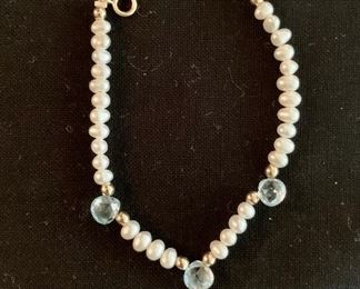 $20 Child's fresh water pearl bracelet with three light blue briolettes and six gold beads.  Clasp marked 14K.