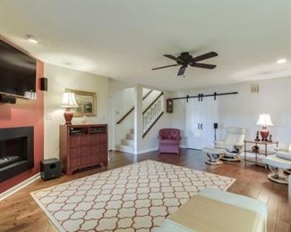 Stressless recliners and ottomans, Sherrill red chair, wool rug.