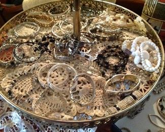 Rotating large tray full of doilies and jewlery