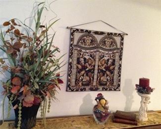 Tapestry, table runner, floral arrangement, faux book boxes, cherub candleholder with florals