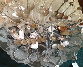 Large divided serving dish full of souvenir spoons