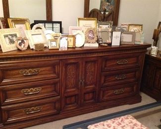 Large dresser with double mirrors and collection of picture frames