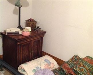 One of a pair of nightstands, lamp, vintage phone/clock/ radio, decorative box, candleholder, candle, bedspreads