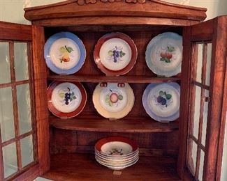 Set of twelve antique fruit bowls and hanging cabinet