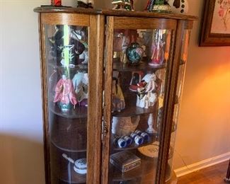 Bow front china cabinet and assorted dolls