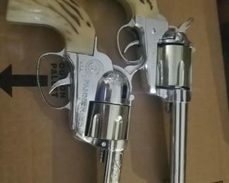 pair of toy guns with holsters