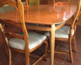 Great mid century table with extra leaf. Includes four chairs.