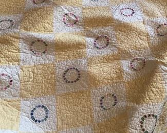 Yellow and white embroidered quilt 