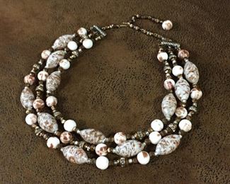 Beautiful triple-strand necklace with vintage oblong and round shaped Venetian glass beads and clear and bronze-colored faceted spacer beads. Flexible length from 14 1/2"-17 1/2". $68
