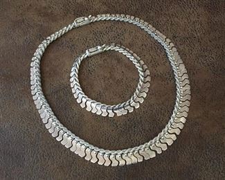 Quality, well made, unique Sterling silver necklace (17" L) and  bracelet (7 3/4" L) set.  Rope silver base with interlocking silver beads attached.  Both have box clasps with safety catches and are stamped 950. Necklace $200, bracelet $125, set $290
