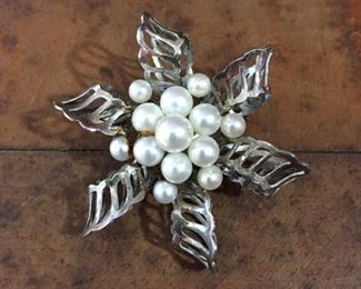 Pretty flower/pinwheel-shaped silver brooch with a cluster of genuine pearls in the center. 1 7/8" diameter, stamped SILVER.  $60

