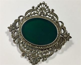Beautiful big 2 3/4" x 2 3/4" Sterling silver brooch with a central green onyx cabochon that's framed all around with sparkly marcasite.  $90
