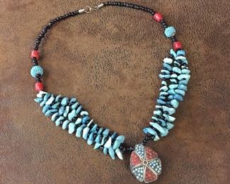 Fabulous 22"  turquoise, coral and black glass beaded necklace with a Tibetan beaded drop pendant. Hook and eye clasp. $98
