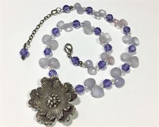 Lovely artisan made beaded necklace with a large detailed Sterling silver flower pendant. Beads include round faceted amethyst, and faceted quartz briolettes with Aurora Borealis Swarovski crystal accents. Flexible length from 16 3/4" to 18 3/4".  Flower pendant is 1 1/8" in diameter.  $160
