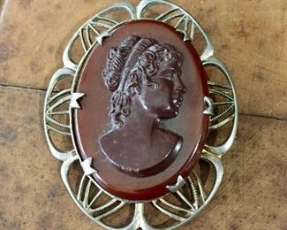 Exquisite carved cameo brooch prong set in a sterling silver frame. Check out the carved details - especially in the curly hair.  Lovely.   Stamped STERLING on back. 1 3/4" x 2 1/8" tall. $80
