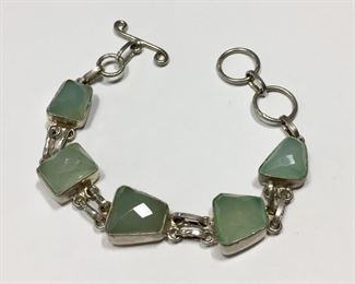 Stunning faceted gemstone and sterling silver link bracelet with toggle clasp.  Flexible length from 6 1/2" to 7 1/4", stamped 925.  $150
