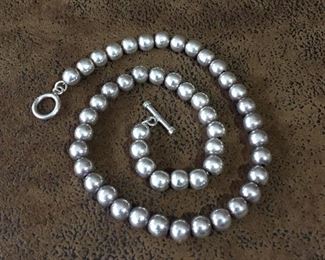 16" Sterling silver beaded necklace with toggle clasp. Beads are all 7mm diameter.  Stamped 925.  $175
