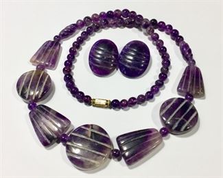 Lovely amethyst necklace and earrings set.  Beaded necklace features 9 hand-carved focal beads.  23 1/2" long with barrel clasp.  Hand carved clip earrings are 7/8" x 1 1/8".  Necklace $140, earrings $50, or set for $160

