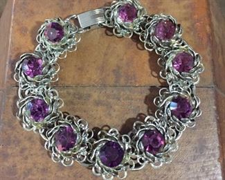 Pretty vintage purple rhinestone bracelet with 10 flower-shaped links.  7 1/4" long.  $80
