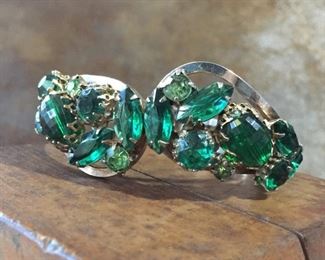 Pretty vintage clamper cuff bracelet, featuring rhinestones in shades of lime and emerald green in round, marquise and oval shapes.  Hinged in the back, opens in center front.   Circumference is 6 1/4".   $88
