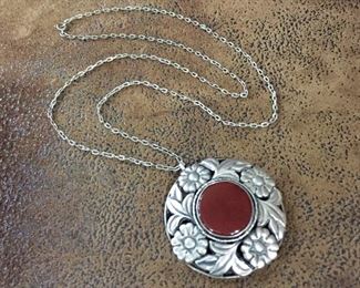Vintage necklace with 24" silver link chain. Has a pretty 800 silver pendant featuring a carnelian cabochon surrounded by a beautiful leafy floral frame. Pendant is 1 3/4" diameter and stamped 800.  $150

