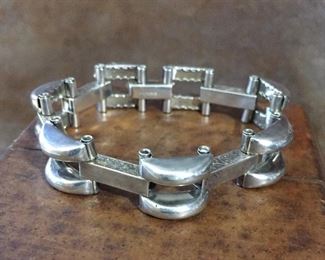 7 1/4" Sterling silver link bracelet. The sides of the bar-shaped links have a textured surface.  Stamped STERLING.  $168
