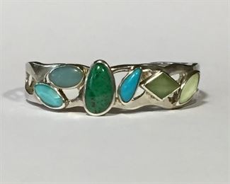 Pretty sterling silver and gemstone cuff bracelet, including turquoise, quartz and chalcedony. Inner circumference is 5 1/4" plus a 1" gap, slightly flexible. $100
