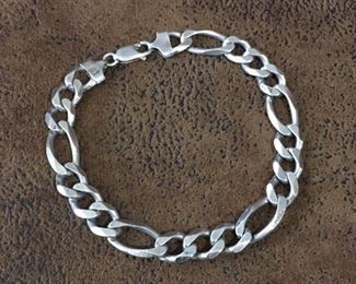 Vintage 9" heavy Italian-made Sterling silver figaro bracelet.  Links are 3/8"wide.  Signed GM and stamped ITALY and 925 on clasp ends.  A classic piece in great condition. $140 
